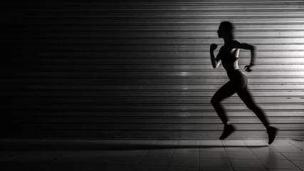 Photo sur Plexiglas Jogging Silhouette of fitness woman running