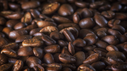 roasted coffee beans on wood texture close up.