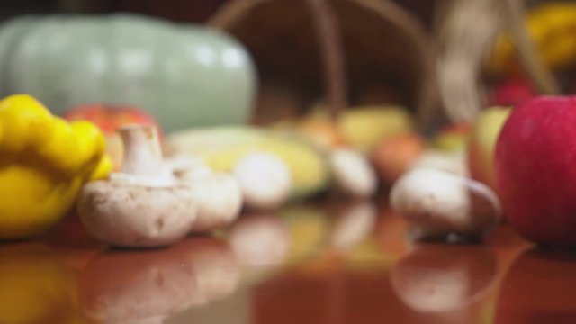 Autumnal Harvest or Thanksgiving, Cornucopia filled with vegetables, vegetables spilled out of the basket on the table. 4k, dolly shot