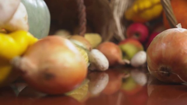 Autumnal Harvest or Thanksgiving, Cornucopia filled with vegetables, vegetables spilled out of the basket on the table. 4k, dolly shot