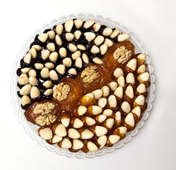 Dried apricots, almonds with walnuts, laid out on a round plate like cake, Armenia, sweets of Armenia