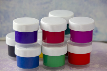 Isolated colored acrylic paints in the plastic bottles