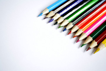 Colored pencils on white background