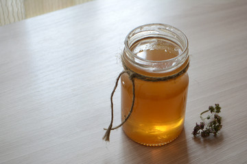 Honey in a transparent jar on the table