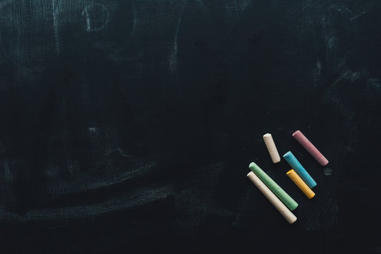 Colorful chalk on blackboard