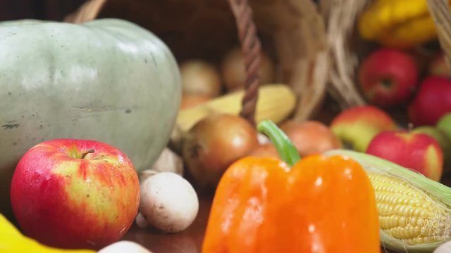 Autumnal Harvest or Thanksgiving, Cornucopia filled with vegetables, vegetables spilled out of the basket on the table. 4k, dolly shot