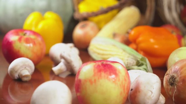 Autumnal Harvest or Thanksgiving, Cornucopia filled with vegetables, vegetables spilled out of the basket on the table. 4k, dolly shot