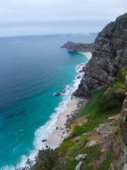rocky cliffs above turquoise blue atlantic ocean at cape point  nature reserve, cape town south africa