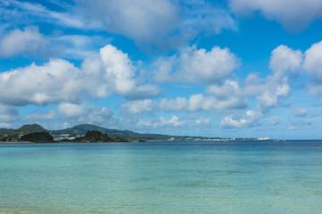 Tropical seascape, Turquoise Sea with Island under blue sky clouds, Travel Vacation, nature sea view in summer at Okinawa, Japan, nature background, copy space