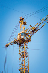 Crane on a blue sky background. Close-up.