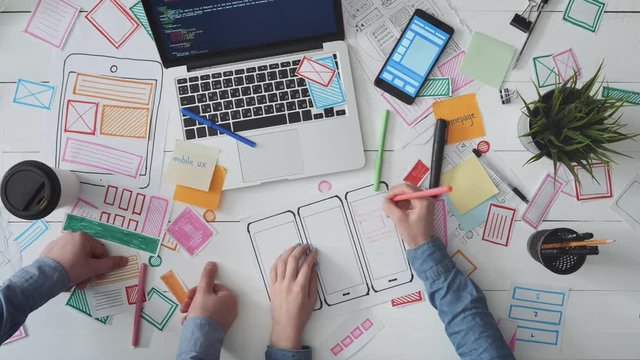 UX designers drawing mobile app layout