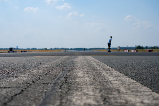 street closeup with man on skateboard in background 