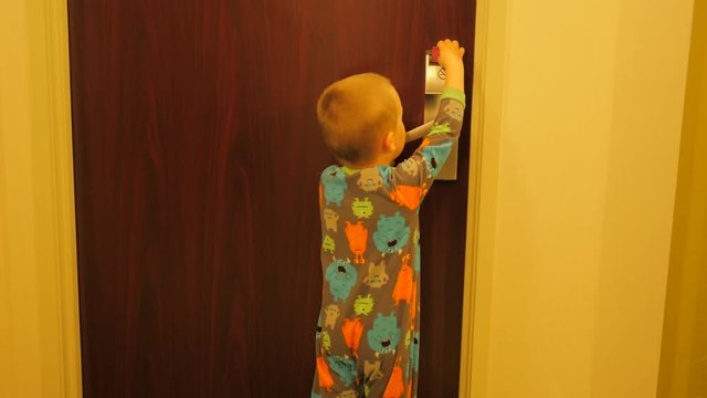 Little kid trying to open hotel room door