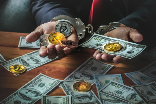 Money and Bitcoin in hands of Businessman with handcuff.