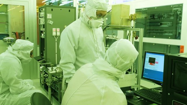 Scientists Working In A Nanofabrication Cleanroom Facility