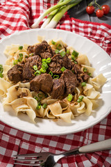Stewed beef with tagliatelle pasta.