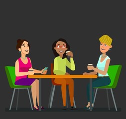 Three girls sitting at a table together talking to coffee break.