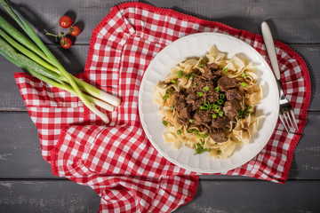 Stewed beef with tagliatelle pasta.