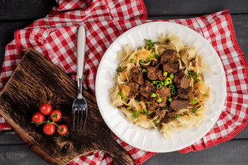Stewed beef with tagliatelle pasta.