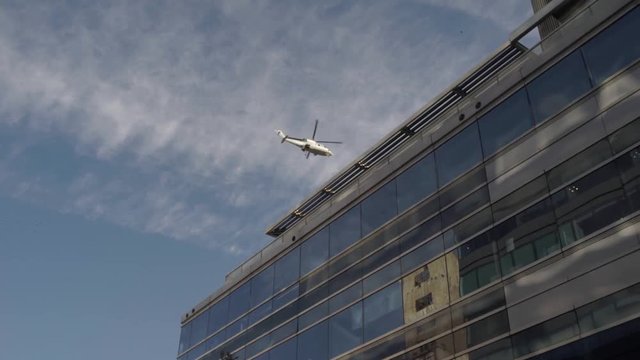 A helicopter flying over a building.