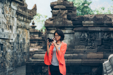 Asian female solo travelers and take photo ancient buildings- Borobudur temple- Java -Indonesia- Asia.