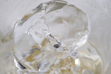 A glass of ice on a white table. Cold drinks on hot days.