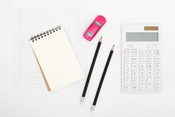 Car expenses calculator, payments costs with paper notes, pencil, payments table, and toy car. Financial and Installment payment concept.