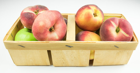 Peaches, apricots and green apples in the basket. isolator of fruit on a white background.