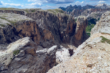 Hiking trail leading through a narrow gorge in the Italian Dolomites along a rocky trail