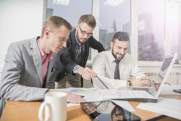 Businessmen that work together in office. Concept of teamwork and partnership