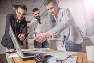 Businessmen that work together in office. Concept of teamwork and partnership