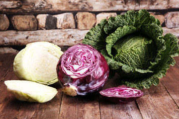 Three fresh organic cabbage heads. Antioxidant balanced diet eating with red cabbage, white cabbage and savoy - obrazy, fototapety, plakaty