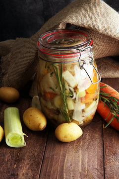 Jar with variety of pickled vegetables. Broth, Carrots, field ga
