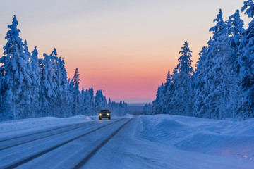 Obraz premium Evening on the winter road in Finland