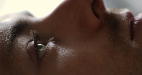 Close-up of man wake up in early morning open eyes