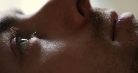 Close-up of man wake up in early morning open eyes