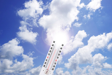 Hot temperature weather concept with thermometer in the sun 
