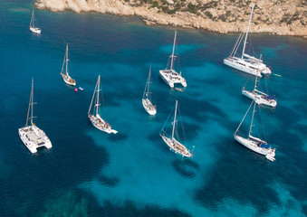 Aerial shot of yachts in a sandy cove