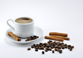 Black coffee in a white porcelain Cup with sugar and cinnamon.