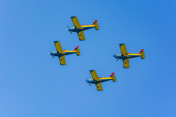 Four Single-Engine Planes Flying at an Airshow