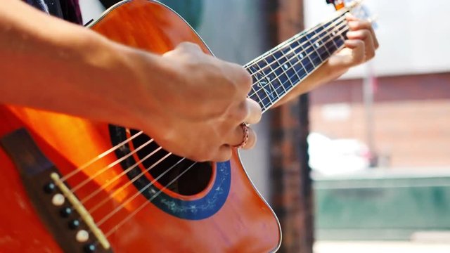 Upbeat playing of guitar outdoors