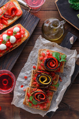 Bruschetta with tomato, basil and mozzarella cheese on wooden board. Traditional italian appetizer or snack, antipasto