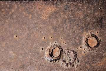 brown metal sheet with two funnels