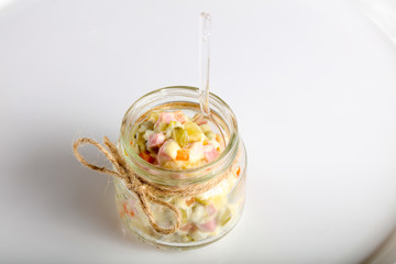 Russian salad in the glass can