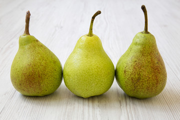 Tasty pears on a white wooden background, side view. Closeup.