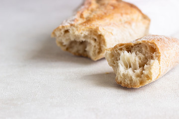 Fresh baguette on the white background, close up.