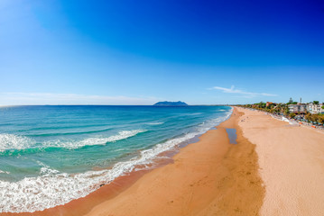 Fototapeta na wymiar Panoramic sea landscape with Terracina, Lazio, Italy. Scenic resort town village with nice sand beach and clear blue water. Famous tourist destination in Riviera de Ulisse