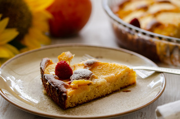 Piece of homemade peaches pie on a plate. Selective focus.
