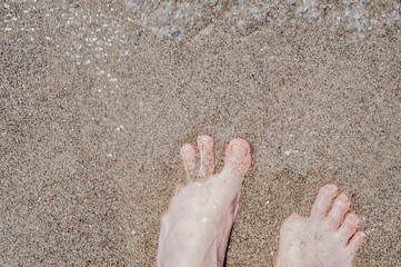 bare feet of an immigrant at the beach