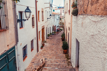 Fototapeta na wymiar Street in Girona, Catalonia, Spain. Scenic and colorful ancient town. Famous tourist resort destination, perfect place for holiday and vacation.